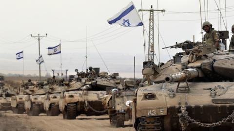 Israeli Merkava tanks drive near the border between Israel and the Gaza Strip on August 5, 2014. (THOMAS COEX/AFP/Getty Images)