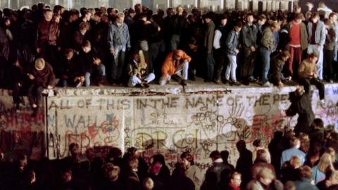 Thousands of young East Berliners crowd atop the Berlin Wall on November 11, 1989. (GERARD MALIE/AFP/Getty Images)