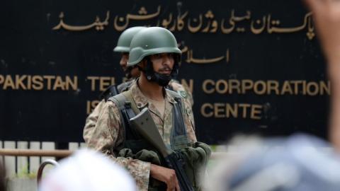 Pakistani soldiers guard the headquarters of state-owned Pakistani Television (PTV) after the building was stormed during anti-government protests in Islamabad on September 1, 2014. (AAMIR QURESHI/AFP/Getty Images)