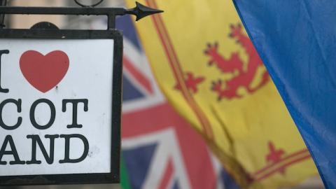 The Saltire flag flies next to the Royal Standard of Scotland and the Union Flag above a gift shop in central Edinburgh on September 19, 2014. (Matt Cardy/Getty Images)