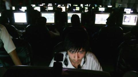 Chinese youngsters play online games overnight at an internet cafe on June 11, 2005 in Wuhan, Hubei Province of China. (Cancan Chu/Getty Images)