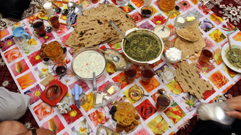 Members of a family attend an iftar, the evening meal to break the daily fast observed by Muslims during the holy month of Ramadan. (ATTA KENARE/AFP/Getty Images)