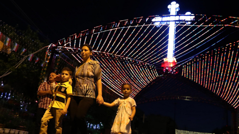 Iraqi Christians walk past a decorations displayed in commemoration of the Elevation of the Holy Cross festival on September 14, 2014, in Arbil, the capital of the Kurdish autonomous region in northern Iraq. (SAFIN HAMED/AFP/Getty Images)