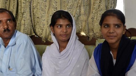 The husband and daughters of Asia Bibi, a Pakistani Christian sentenced to death for "blasphemy," at their residence in Lahore, October 13, 2014 (Arif Ali/AFP/Getty Images).