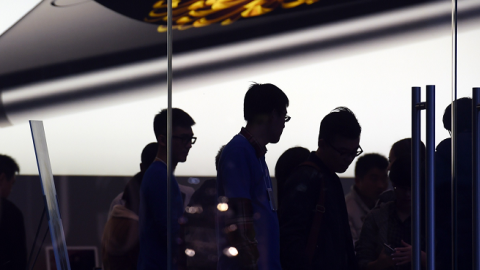 Store attendants help customers at an Apple store selling the iPhone 6 in Beijing on October 23, 2014. (GREG BAKER/AFP/Getty Images)