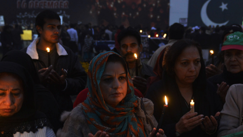 Pakistani civil society activists pray during a vigil in Lahore on December 18, 2014, for the children and teachers killed in an attack by militants on an army-run school in Peshawar. (Arif Ali/AFP/Getty Images)