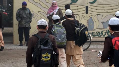 Pakistani children arrive at their school in Peshawar on December 20, 2014, after three days of mourning for the children and staff killed by Taliban militants in an attack on an army-run school. (A Majeed/AFP/Getty Images)