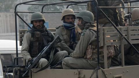 Pakistani soldiers provide security during a mass prayer for the victims of a school massacre, in Peshawar on December 21, 2014. (A Majeed/AFP/Getty Images)