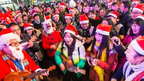 People dressed in Santa Claus costumes attend a celebration for the Christmas Eve at Xinjiekou on December 24, 2013 in Nanjing, China. (ChinaFotoPress/Getty Images)