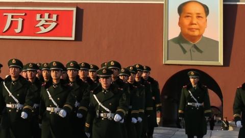 Paramilitary policemen patrol in front of Tiananmen Gate on November 17, 2013 in Beijing, China. (Feng Li/Getty Images)