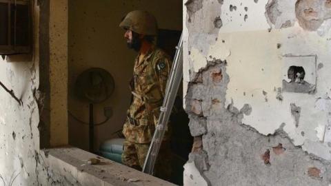Pakistani army soldiers stand guard at the site of the militants' attack on the army-run school in Peshawar on December 18, 2014. (A Majeed/AFP/Getty Images)