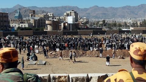 Yemeni soldiers watching a funeral for policemen killed by a car bombing in Sanaa, January 9, 2015 (Mohammed Huwais/AFP/Getty Images).