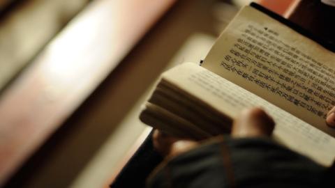 A catholic reads the Bible at the temporary Bailu Township Church on December 24, 2008 in Pengzhou of Sichuan Province, China. (China Photos/Getty Images)