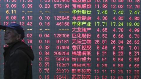 Investors watch a digital screen displaying the prices of China's stock market on January 5, 2015 in Hangzhou, Zhejiang province of China. (ChinaFotoPress via Getty Images)