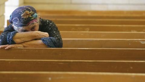 An Iraqi Christian fleeing the violence in the towns of Qaraqush and Bartala prays at the Saint George church on July 1, 2014 in the Kurdish autonomous region's capital Arbil. (KARIM SAHIB/AFP/Getty Images)