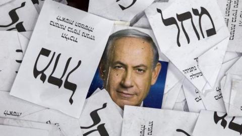 Copies of ballots papers and campaign posters for Israel's Prime Minister Benjamin Netanyahu's Likud Party on March 18, 2015 in Tel Aviv. (JACK GUEZ/AFP/Getty Images)