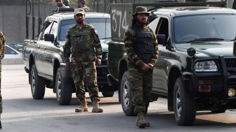 Pakistani soldiers cordon off the site of an attack by Taliban gunmen on a school in Peshawar on December 16, 2014. (A Majeed/AFP/Getty Images)