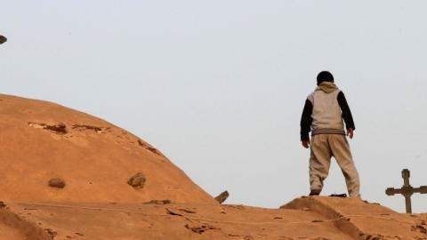 An Egyptian Coptic boy looks down from the roof of the Bishoy Monastery in Beheira province, 150 kms northwest of Cairo. (KHALED DESOUKI/AFP/Getty Images)