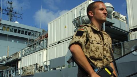 A German soldier guards the German military supply ship Elbe at the port February 21, 2003 in Djibouti Town, Djibouti. (Sean Gallup/Getty Images)