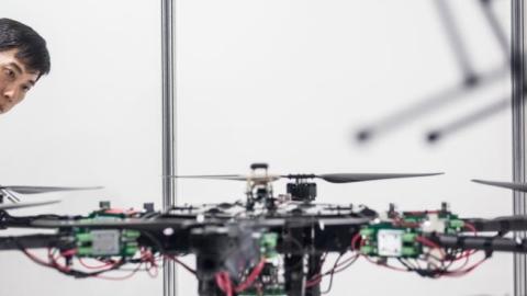 A man looks at drones on display at the International Drone Expo 2015 at Makuhari Messe on May 21, 2015 in Chiba, Japan. (Chris McGrath/Getty Images)