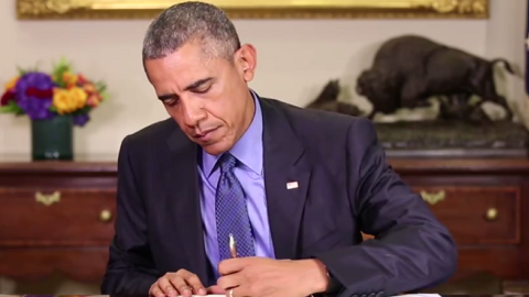 Screenshot of President Obama signing an order commuting the sentences of 46 convicts (Facebook)
