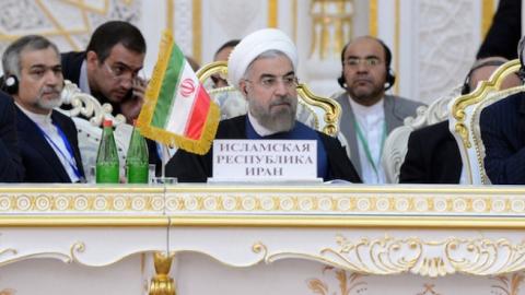 Iran President Hassan Rouhani (C) attends the Shanghai Cooperation Organization (SCO) Summit in Dushanbe, Tajikistan, September 12, 2014. (Kyrgyzstan Presidential Office Press Center/Pool/Dosaliev Sultan/Anadolu Agency/Getty Images)