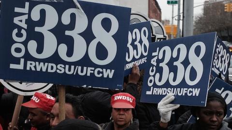 Workers and supporters hold up union signs during a rally, March 4, 2015, Brooklyn NY. (Spencer Platt/Getty Images)