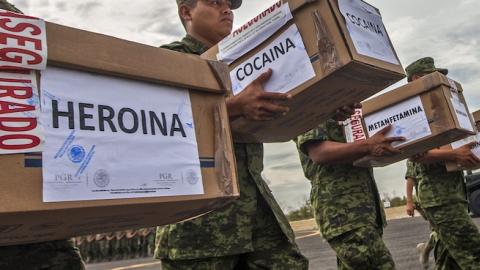 Members of the Mexican Army carry boxes with heroin, cocaine and methamphetamine to be incinerated at a military base in Monterrey, Nuevo Leon state, on August 23, 2013. (Julio Cesar Aguilar/AFP/Getty Images)