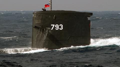 A navy soldier salutes from the Dutch-made Sea Dragon submarine during a combat skills demonstration in the watersnear the Tsoying navy base in southern Kaohsiung on January 14, 2014. (SAM YEH/AFP/Getty Images)