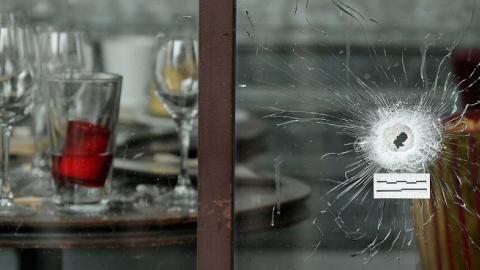 Bullets holes are seen through the glass door of a cafe near Casa Nostra after the terror attack on November 14, 2015 in Paris, France. (Christopher Furlong/Getty Images)