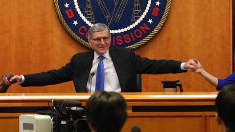 FCC Chairman Tom Wheeler (C) holds hands with FCC Commissioners Mignon Clyburn (L) and Jessica Rosenworcel during an open hearing on Net Neutrality at the FCC headquarters February 26, 2015 in Washington, DC. (Mark Wilson/Getty Images)