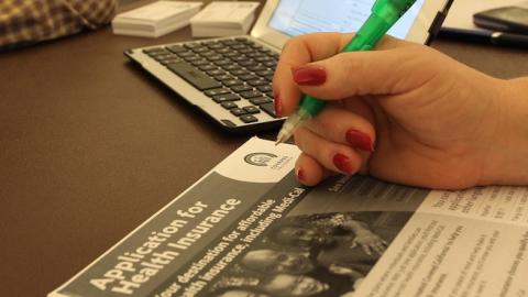 A healthcare reform specialist helps people select insurance plans at the free Affordable Care Act (ACA) Enrollment Fair at Pasadena City College on November 19, 2013 in Pasadena, California. (David McNew/Getty Images)