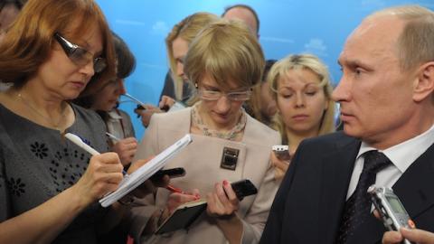 Russia's Prime Minister Vladimir Putin (R) speaks with journalists of the government press pool in Moscow on March 7, 2012. (ALEXEY NIKOLSKY/AFP/Getty Images)