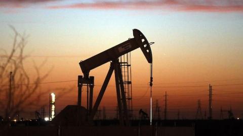 An oil pumpjack works at dawn in the Permian Basin oil field on January 20, 2016 in the oil town of Andrews, Texas. (Spencer Platt/Getty Images)