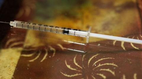 A syringe used for intravenous drug use lies on a table in a room on February 6, 2014 in St. Johnsbury, Vermont. (Spencer Platt/Getty Images)