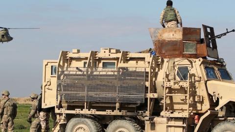 Military personnel arrive in a Chinook before Iraqi soldiers take part in a live-fire exercise for under the surveillance of US-led coalition forces at Basmaya base, Iraq on January 27, 2016. (AHMAD AL-RUBAYE/AFP/Getty Images)