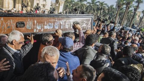 Egyptians mourners carry the coffin of the Egyptian journalist Mohamed Hassanein Heikal during his funeral at the al-Hussein mosque in Cairo on February 17, 2016. (KHALED DESOUKI/AFP/Getty Images)