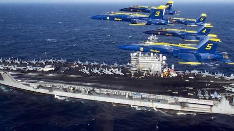 The U.S. Navy flight demonstration squadron, the Blue Angels, fly in the Delta Formation over the aircraft carrier USS George H.W. Bush off the Florida coast near Mayport Naval Station, Fla., in the Atlantic Ocean, Dec.10, 2013. (DoD/Released)
