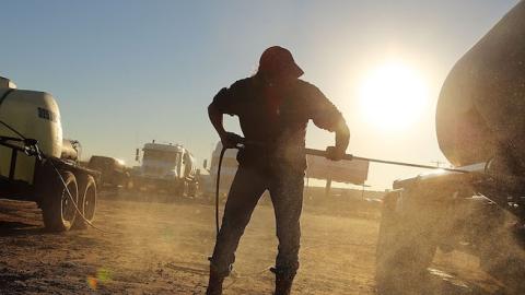 A truck used to carry sand for fracking is washed in a truck stop on February 4, 2015 in Odessa, Texas. (Spencer Platt/Getty Images)