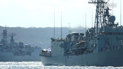 Royal Australian Navy warships HMAS Darwin (R) and HMAS Parramatta enter Sydney Harbour on October 4, 2013 in Sydney, Australia. (Cameron Spencer/Getty Images)