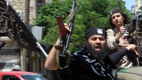 Fighters from Al-Qaeda's Syrian affiliate Al-Nusra Front drive in the northern Syrian city of Aleppo flying Islamist flags as they head to a frontline, on May 26, 2015. (Fadi al-Halabi/AFP/Getty Images)