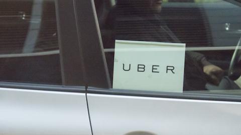 Man driving a sedan with Uber sticker on it, New York City, October 17, 2015. (Roberto Machado Noa/LightRocket via Getty Images)
