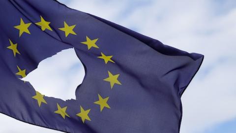 A European Union flag, with a hole cut in the middle, flies at half-mast outside a home on June 24, 2016 in Knutsford, United Kingdom. (Christopher Furlong/Getty Images)