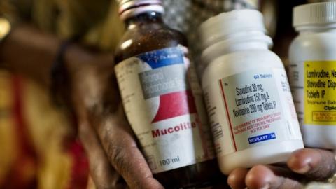 Heer Pardesi, who is 42 years old, holds her antiretroviral drugs for HIV. (Jonas Gratzer/LightRocket via Getty Images)