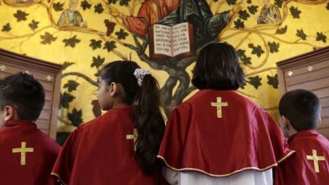 Iraqi Christian children, who fled the violence in the Nineveh province, attend a mass with their mothers at a chuch in Dekwaneh, east of the Lebanese capital Beirut on March 21, 2015. (ANWAR AMRO/AFP/Getty Images)