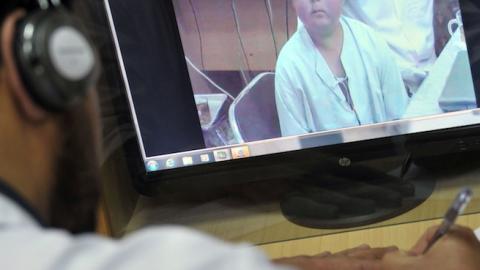 French Hospital Institute for Children doctor talks face to face with a patient from Kabul, on May 13, 2012 (Photo: BAY ISMOYO/AFP/Getty Images)