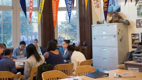 College banners hang in the classroom of teacher Chrys Latham, as she leads a senior advisory period, at Washington Latin Public Charter School, in Northwest Washington, D.C., October 23, 2015. (Allison Shelley/For The Washington Post via Getty Images)