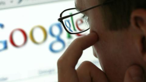 Man in front of a display with the website of the internet search engine Google, Germany. (Ulrich Baumgarten via Getty Images)