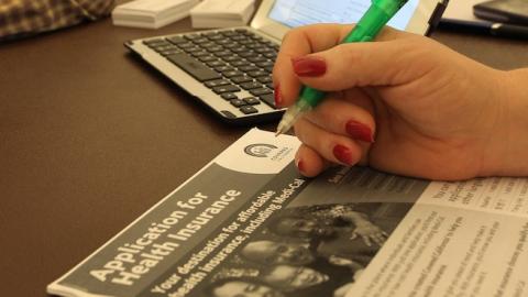 A healthcare reform specialist helps people select insurance plans at the free Affordable Care Act (ACA) Enrollment Fair at Pasadena City College on November 19, 2013 in Pasadena, California. (David McNew/Getty Images)