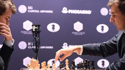 Chess grandmaster and current world chess champion Magnus Carlsen (L) of Norway with challenger Sergey Karjakin of Russia during their World Chess Championship 2016 round 1 match in New York, November 11, 2016. (JEWEL SAMAD/AFP/Getty Images)